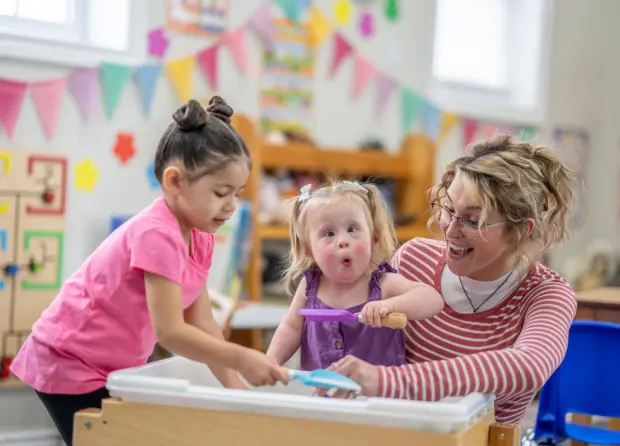 Children and teacher playing in classroom
