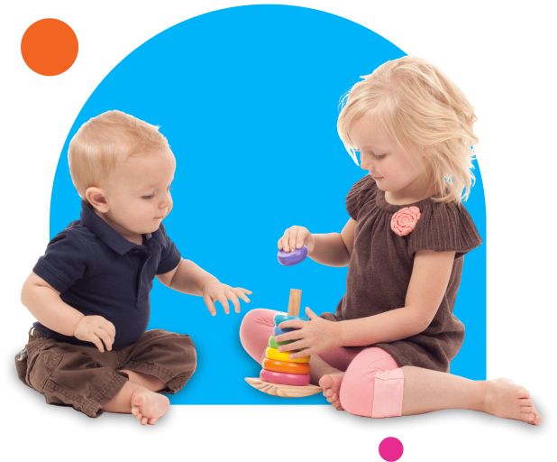 Toddlers interacting with stacking toy