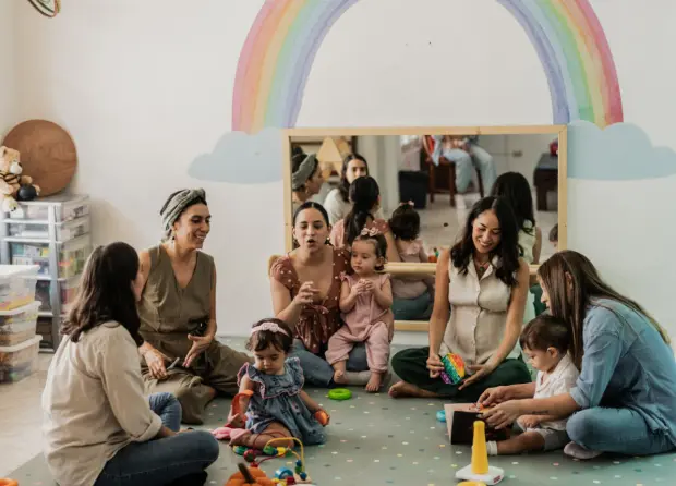 Group of women and children playing indoors